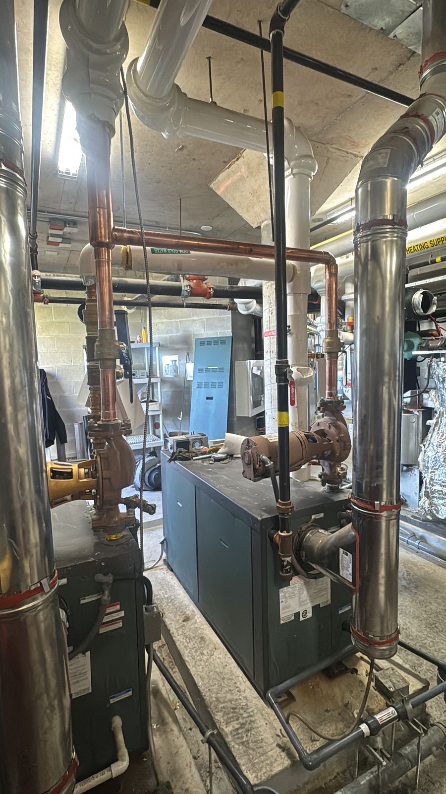 Boiler room with boiler, circulator pumps and copper piping